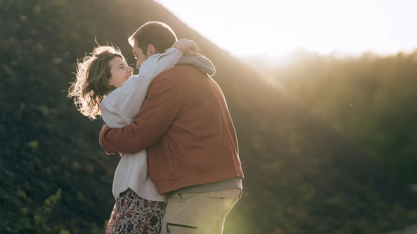 Hélène et Benoît s'enlacent dans la lumière du soir